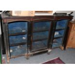 A mid-19th century inverted breakfront ebonised inlaid and gilt metal mounted display cabinet (