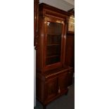 A 19th century walnut bookcase cabinet, the upper section with a glazed door, flanked by reeded