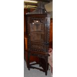 An 18th century carved oak glazed corner cupboard on stand, 67cm by 40cm by 207cm high