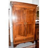 An 18th century French armoire with cupboard doors enclosing hanging space, with a deep drawer to