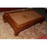 A 20th century Chinese hardwood coffee table with rattan top, 166cm wide by 86cm deep by 42cm high