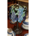 A large Tiffany style table lamp, the shade decorated in blues and greens