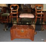 A Chinese carved camphor wood chest, 100cm by 50cm by 56cm high (a.f.); together with two cane-