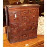 A small 19th century table-top cabinet of fifteen drawers made up of cigar boxes