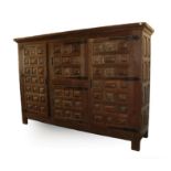 A Large Arts & Crafts Oak Linen Cupboard, adzed all over, with a rectangular top over two cupboard