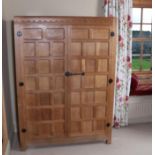 Workshop of Robert Mouseman Thompson (Kilburn): An English Oak Panelled Wardrobe, with half penny