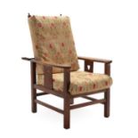 An Arts & Crafts Oak Reclining Lounge Chair, shaped arms above a slatted side with pierced heart