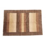 Hand-knotted Modernist rug, the panelled field in a soft pallet enclosed by pale walnut borders,