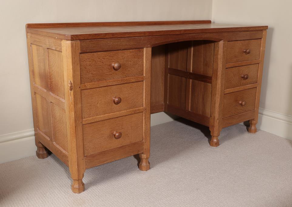 Workshop of Robert Mouseman Thompson (Kilburn): An English Oak Panelled Kneehole Dressing Table/