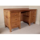 Workshop of Robert Mouseman Thompson (Kilburn): An English Oak Panelled Kneehole Dressing Table/