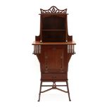 An Art Nouveau Mahogany Music Cabinet, the upper section with pierced fret cut cornice above an open
