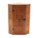 Workshop of Robert Mouseman Thompson (Kilburn): An English Oak Hanging Corner Cupboard, circa