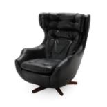 A Parker Knoll Statesman Egg Chair, with swivel and tilt mechanism, black vinyl upholstery with