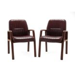 A Pair of Vaghi Armchairs, laminated wood frames, upholstered in oxblood leather, labelled VAGHI,