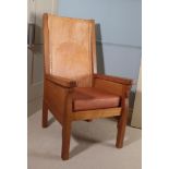 Workshop of Robert Mouseman Thompson (Kilburn): An English Oak Smoking Chair, slung leather back,