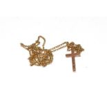 A 9 carat gold cross pendant on a 9 carat gold chain, pendant length 3.5cm, chain length 71cm. Gross