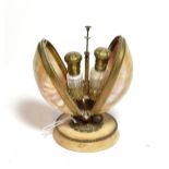A pair of Victorian brass mounted glass scent bottles, in fitted hinged shell and brass stand, on