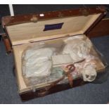 * A large travelling case containing an assortment of 19th/20th century textiles, costume, lace