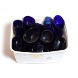 A quantity of blue glass liners for salt cellars and other dishes in various shapes and sizes