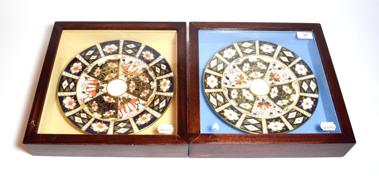A pair of Royal Crown Derby plates, in framed and glazed wall hanging display cases