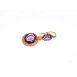 A single amethyst drop earring, an oval cut amethyst within a yellow beaded border surmounted by a