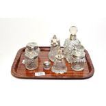 Eight various silver mounted cut jars scent-bottles and dressing-table jars, variously decorated (8)