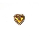A citrine and split pearl brooch, the heart shaped citrine in a yellow rubbed over setting, within a