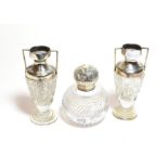 A pair of silver mounted cut glass silver vases together with a silver mounted cut glass bottle (3)