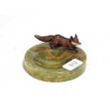 An Austrian cold painted model of a fox, mounted on a green onyx circular pin dish/ ashtray