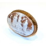 A carved cameo in Elizabeth II gold stand, the stand 1976, 9ct, the cameo carved with three