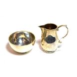 A George V silver cream jug and a George V silver sugar bowl, the cream jug by G. Unite and Sons and