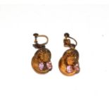 A pair of drop earrings with pink stones, the yellow swirl motifs with ropetwist decoration