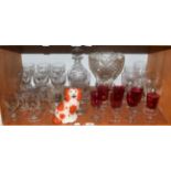 A large cut glass pedestal bowl, decanter and stopper, various wine glasses and seven cranberry