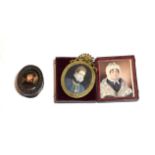 An enamelled portrait miniature of a gentleman in carved wood frame, together with a further