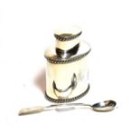 A silver tea caddy and a silver spoon (2)