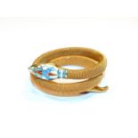 An enamel snake bangle, with paste set eyes. The bangle is gilt metal. Gross weight 22.8 grams.