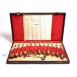 A cased set of twelve gilt-metal coffee spoons, apparently unmarked, circa 1900, each with a