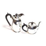 An Edward VII silver teapot, by Nathan and Hayes, Chester,1906, bullet-shaped and with ebonised