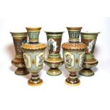 Mettlach vases comprising, a pair decorated with stylized flowers and painted cartouche of