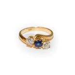 A sapphire and diamond three stone twist ring, a round cut sapphire flanked by old cut diamonds,