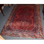 A Kashgai rug, the scarlet field with three stepped medallions enclosed by multiple borders, 225cm