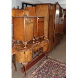 A six piece burr walnut veneered bedroom suite comprising a triple door wardrobe, two bedside