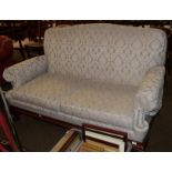 An Edwardian style two-seater sofa on claw and ball feet, upholstered in light grey damask fabric