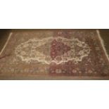 An Isfahian rug, the cream field of vines around a pole medallion, framed by spandrels and