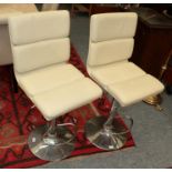 A pair of Art Deco style cream leatherette and chrome swivel chairs (2)