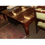 A Victorian mahogany extending dining table with two additional leaves