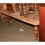 * A Victorian mahogany extending dining table with single leaf, raised on turned legs to castors
