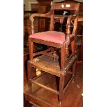 A 19th century child's highchair on stand