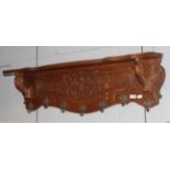 A carved oak coat rack