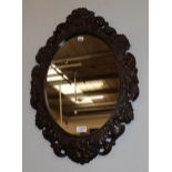 A Victorian style carved oak mirror